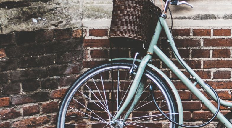 Bicycle up against a brick wall