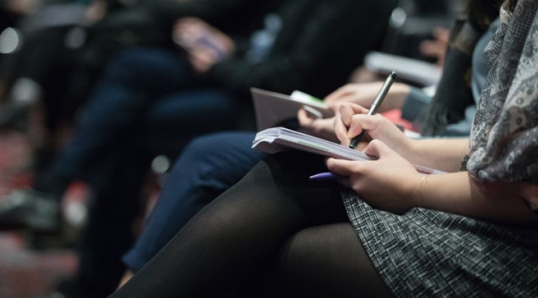 Woman using a notebook in a class